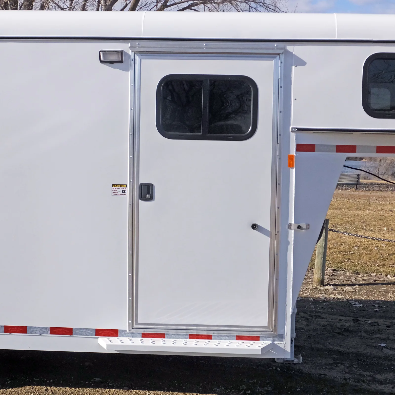 Maverick 4 horse gooseneck camper tack door with slider window.